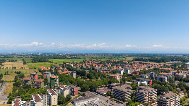 Aerial View of a European Town: An expansive aerial panorama showcases a charming European town nestled amidst verdant countryside, Peschiera Borromeo, Italy