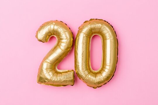 20th anniversary celebration golden number 20 balloon on a pink background birthday party and special event