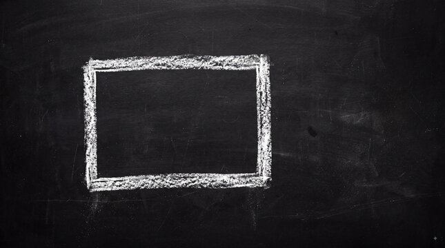 Hand drawn white chalk rectangle frame on black chalkboard background with empty copy space for classroom notes, menu design, announcements and education concepts