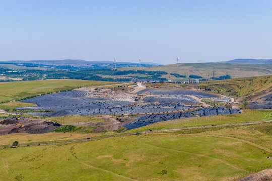 High angle shot of landfill site and refuse management facility, processing domestic and commercial waste in open countryside, South Wales