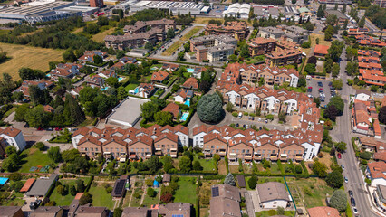 Fototapeta premium Aerial View of Residential Complex: An aerial shot showcases a sprawling residential complex featuring apartment buildings, townhouses, Bellaria, Peschiera Borromeo, Italy