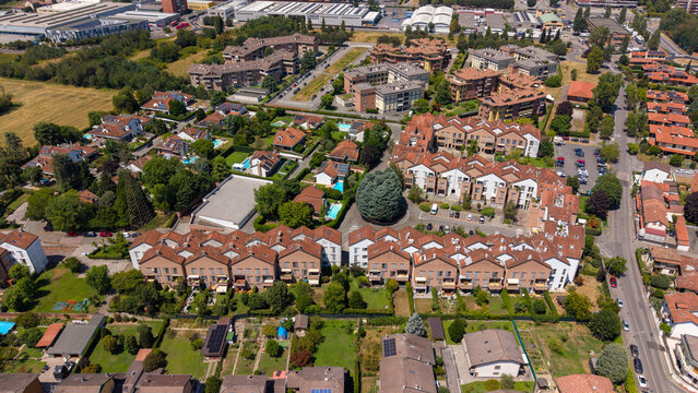 Aerial View of Residential Complex: An aerial shot showcases a sprawling residential complex featuring apartment buildings, townhouses, Bellaria, Peschiera Borromeo, Italy