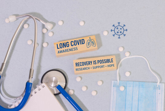 Long COVID Awareness Concept with Stethoscope, Face Mask, Pills and Recovery Message.