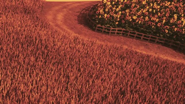 A winding path goes through a wheat field. Bright flowers are on one side. The sun sets in the background, creating an orange glow in the sky.