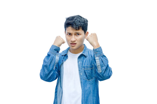 Frustrated young man with clenched fists isolated on white background