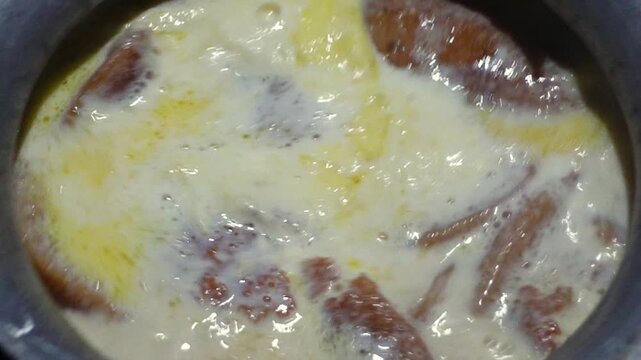 Date juice was cooked and turned red, and the Chitai Pitha was dipped in it, now milk is poured into it, which will be called Dudh-Chitai Pitha.
