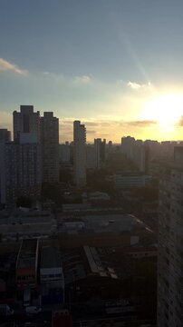 Sunset between buildings in the Lapa neighborhood of Sao Paulo_vertical.