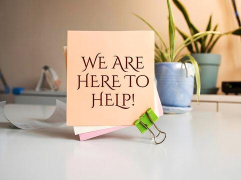 We Are Here To Help Inspirational Sticky Note On Office Desk With Green Binder Clip Customer Support Assistance And Positive Workplace Message