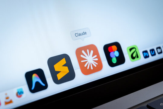 Mexico City, Mexico, 02 25 2026: A macro shot of a laptop screen showing the Claude AI desktop app icon alongside Figma and Adobe application icons.