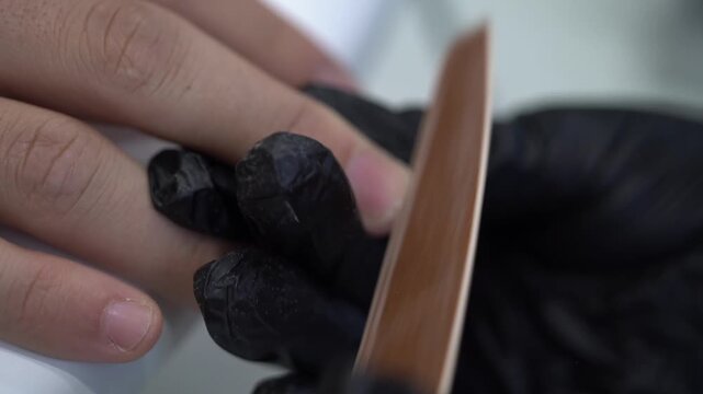 Natural Fingernail Shaped With Emery Board During Manicure