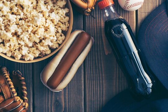 Classic baseball game day spread with popcorn, hot dog, and soda