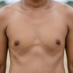 Naklejka premium Close up of a young mans bare chest and torso, body image and health, human anatomy and skin texture