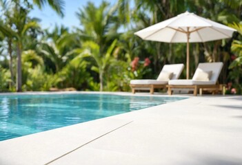 Fototapeta premium White tiled poolside terrace with blurred luxury swimming pool and lush greenery, ideal for product display, summer travel, hospitality, resort, relaxation, and branding.