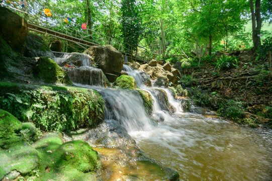Tranquil Namtok Waterfall Behind a Lush Green Gorge in Nature