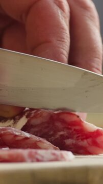 Mix of spanish pork sausages, Cutting board of appetizing catalonian snack - fuet, jamon, chorizo, olives, supermarket tapas food in spain, traditional cuisine. 