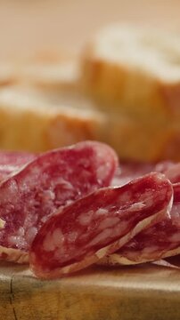 Mix of spanish pork sausages, Cutting board of appetizing catalonian snack - fuet, jamon, chorizo, olives, supermarket tapas food in spain, traditional cuisine. 