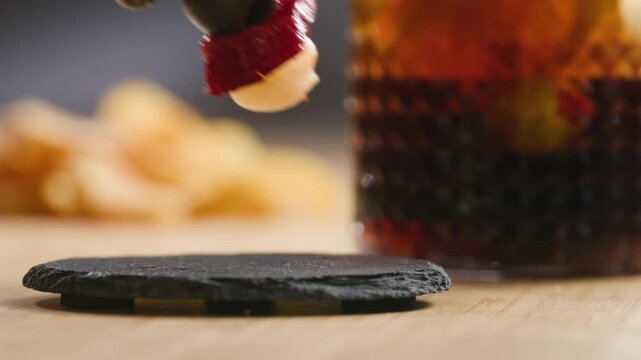Traditional Spanish red vermouth served with Gilda tapas on a bar table in a cafe or restaurant. Classic aperitif with pickled olives, anchovies and peppers, authentic Spanish cuisine.