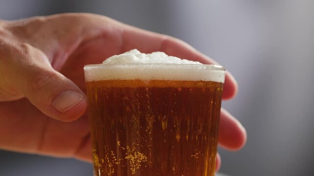 Fresh Spanish small beer served in a small glass with creamy foam at a traditional bar. Classic draft lager, authentic pub atmosphere, close-up food and drink