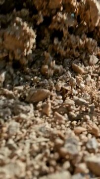 Close-up of Falling Brown Soil and Earth Particles