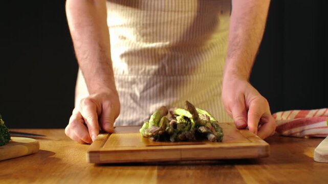 Fresh green asparagus on kitchen with broccoli and green pepper, vegan healthy food. Bunch of green asparagus close-up