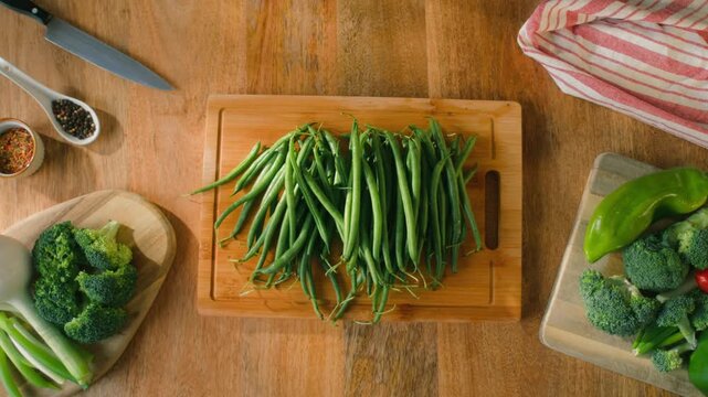 Fresh green beans and vegetables on a wooden table, spanish extra fine beans, chinese long bean. 