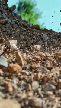 Gravel and dirt particles falling in slow motion