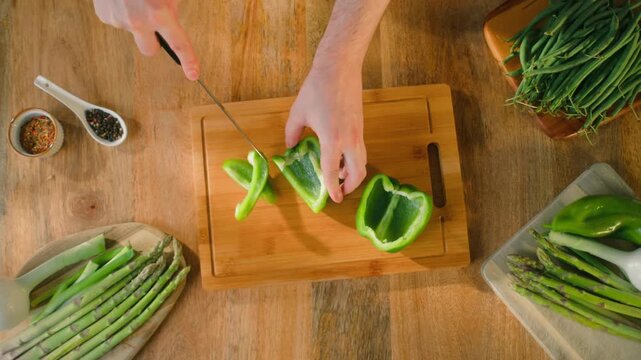 Man cut green sweet pepper, Healthy food, Chef hands with knife for onion, cutting and preparation with cooking for dish. Restaurant, culinary service and cook with skills for catering