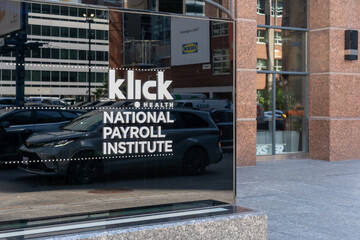 Fototapeta premium Toronto, Ontario, Canada - August 5, 2026: A directory sign marks Klick Health and National Payroll Institute outside the office building on Bloor Street East in Toronto, Ontario, Canada. 
