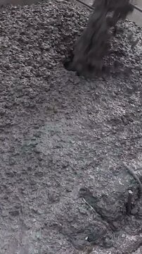 Wet cement pouring from a construction mixer truck