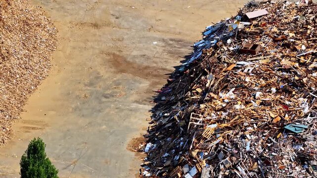 Aerial Pan Over Large Scrap Metal Recycling Stockpile at Port of Bordeaux Industrial Facility France