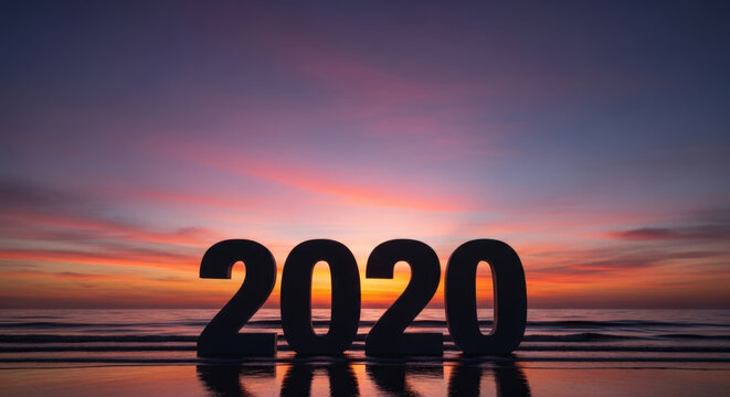 Large 2020 numbers on ocean beach at sunset, with a vibrant sky reflecting in the water, symbolizing a new year beginning.