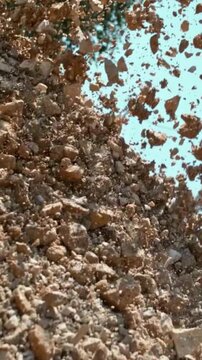 Industrial Excavator Dumping Crushed Stone Gravel at Construction Site