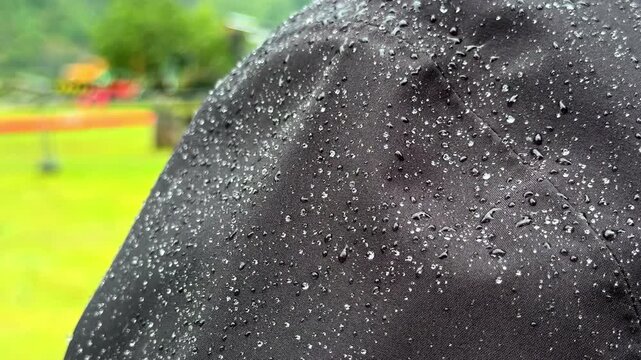 Detailed view of rain jacket with beading water on the surface
