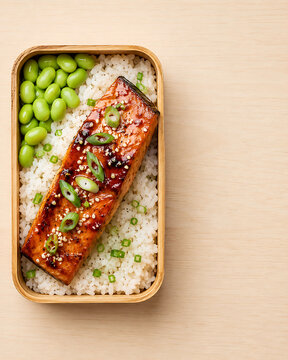 Japanese Teriyaki Salmon Bento Box with Rice, Edamame, and Green Onions
