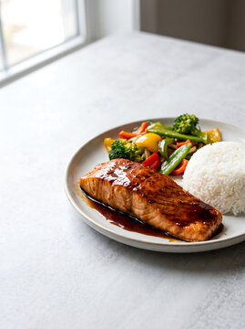 Healthy Teriyaki Salmon Meal with White Rice and Stir Fried Vegetables on Plate
