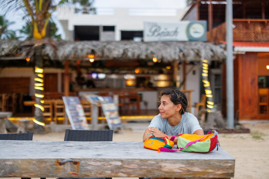 Galapagos beach bar with woman at table