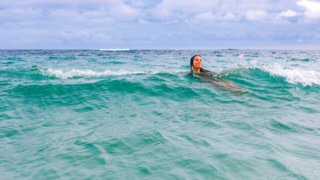 Girl swimming in waves