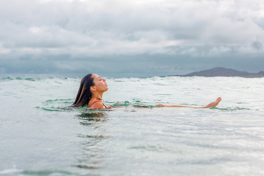 Woman coming up for air, in ocean