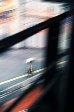 Blurred Pedestrian with Umbrella in Rain