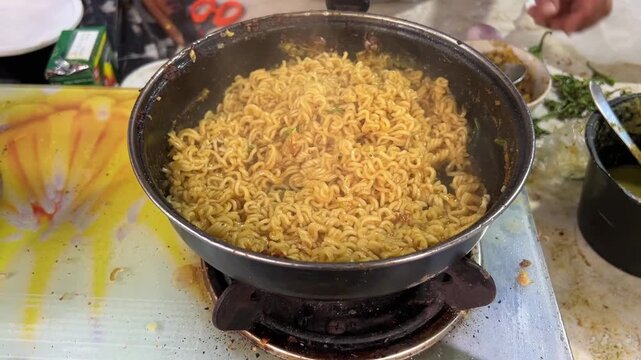 Egg maggi and litti chokha being cooked in a road side dhaba in India