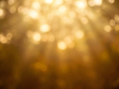 Abstract golden background with glowing light particles and soft bokeh effect for festive holiday design projects