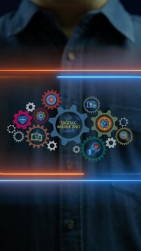 Businessman hands vertical shot supporting glowing gear wheel mechanism with Digital Marketing text overlay and marketing icon gears. Digital marketing engine and online campaign strategy concept.