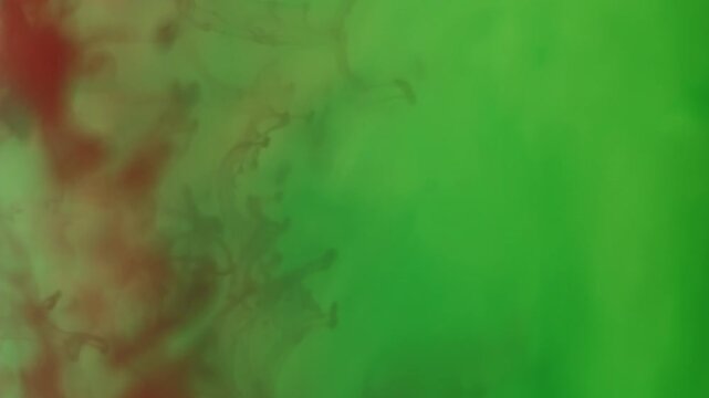 Vertical video. Splash ink. Liquid texture. Defocused green red crimson color acrylic water flowing smog floating on abstract art creative background.