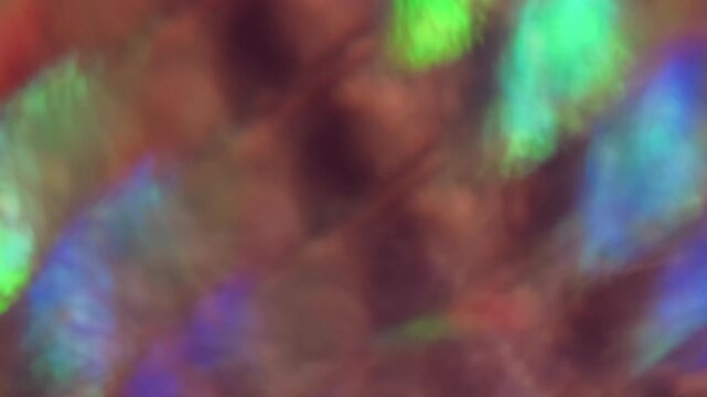 Defocused glisten gleam. Flicker light. green blue yellow color flare radiant art illuminated flash on abstract optical luminous background.