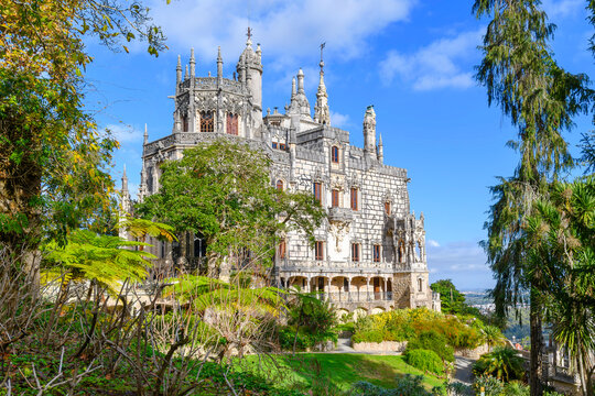 The main facade of the Regaleira Palace nestled within the lush, mystical Quinta da Regaleira estate in Sintra, Portugal.