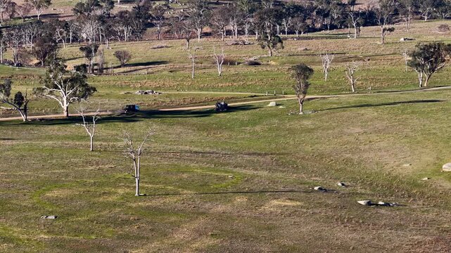 Vehicle Driving on Dirt Road Through Rural Australian Countryside