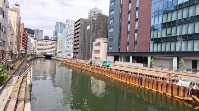 Urban Canal with Construction Site and Modern Buildings in Tokyo
