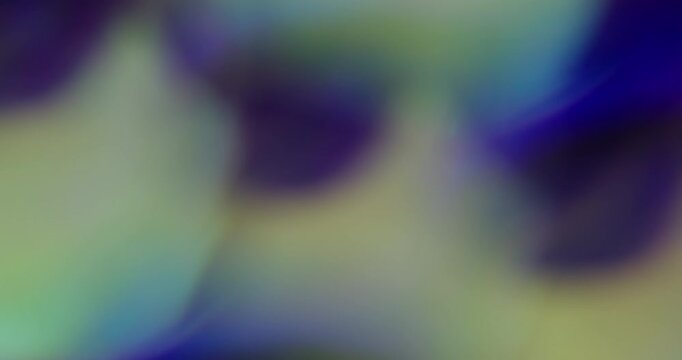 Bokeh texture. Bright light. Purple blue yellow colorful lens flare optical glisten kaleidoscope on abstract luminous art background.