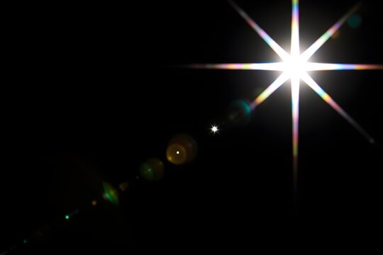 Lens flare glow light effect on black. image of rays light effects, overlays or flare isolated on black background for design. lens flare light over black background