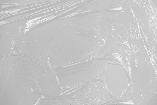 plastic overlay texture of realistic crumpled transparent plastic film wrap on white background, wrinkled stretched plastic effect. plastic background on transparent png